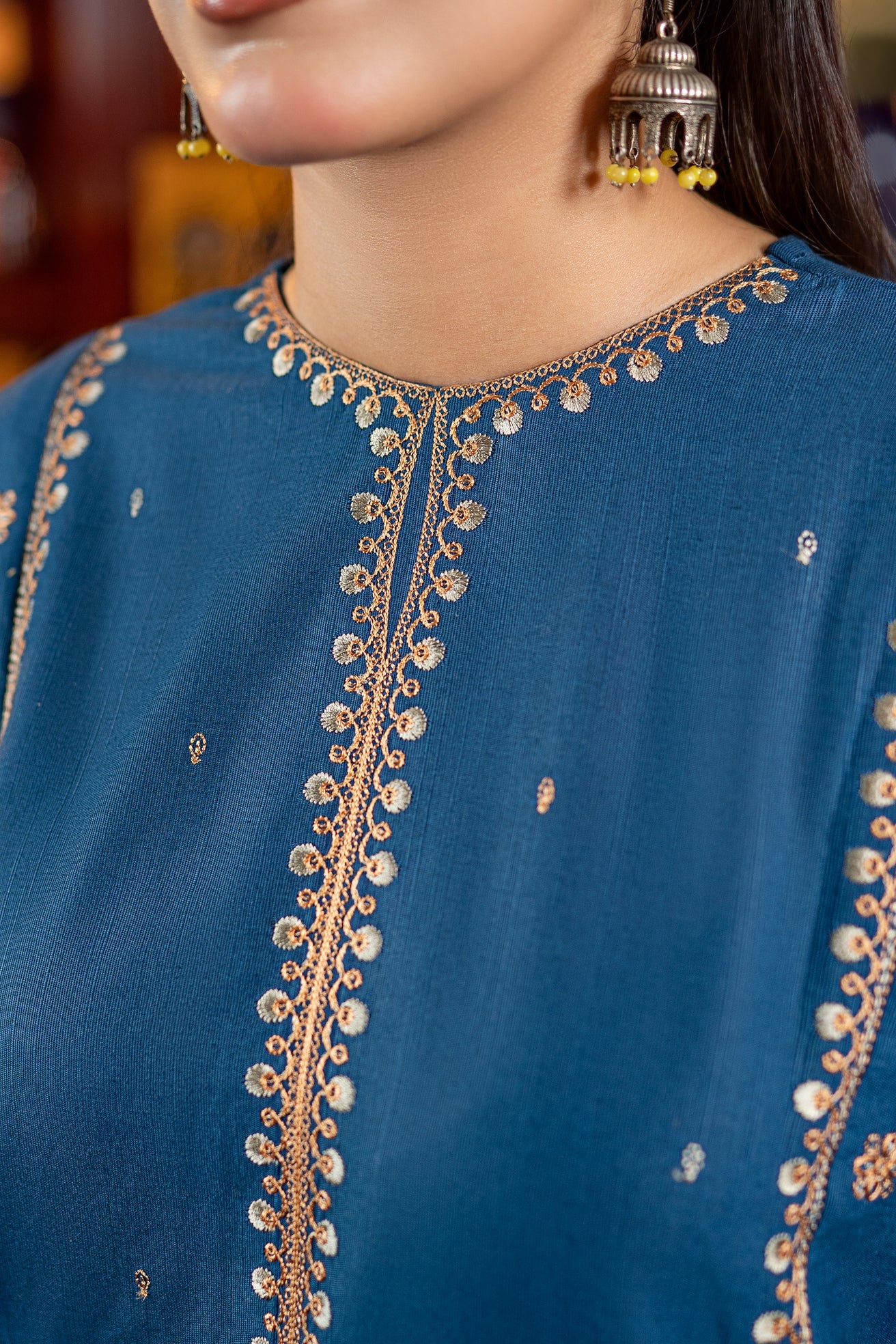 2PC Khaddar Embroidered Suitlong shirt adorned with intricate embroidery on the front and detailed embroidery on loose sleeves